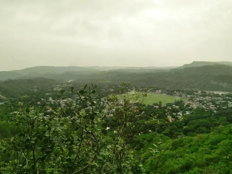 Hamirpur hill town view with houses, roads and green slopes in Himachal Pradesh