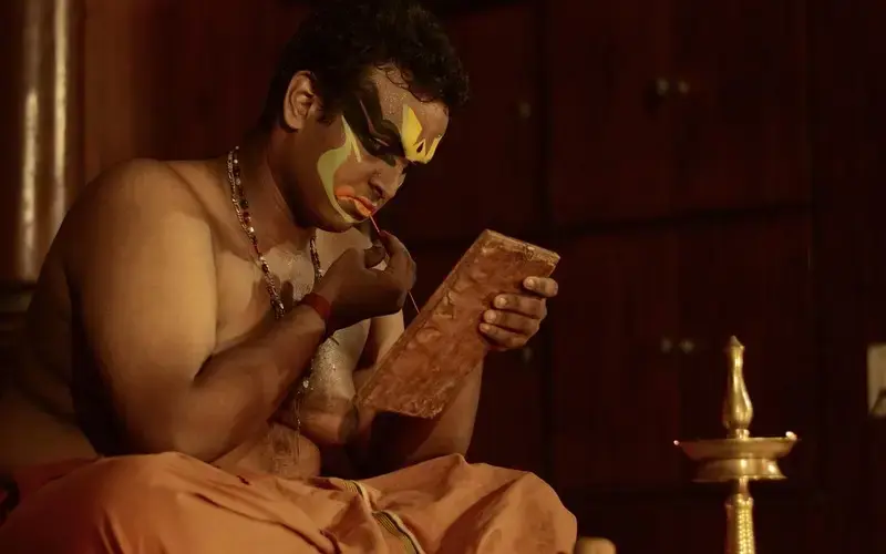 Kerala backwaters with houseboats, palm trees, and calm water under a bright sky.”